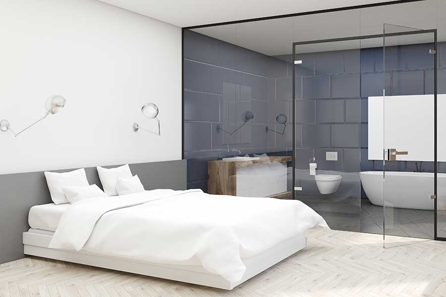 Glass partition wall between bathroom and ensuite bathroom