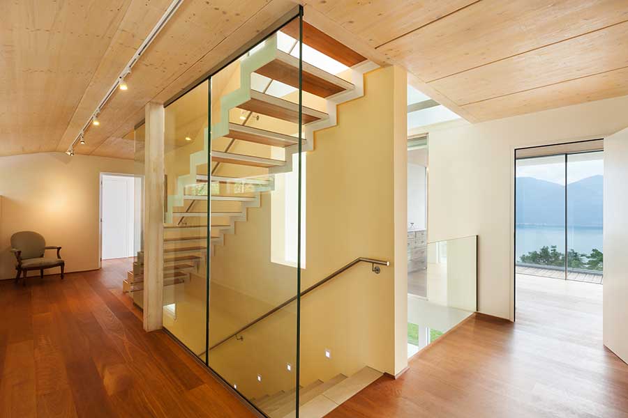 Glass partition walls allow light into this basement staircase