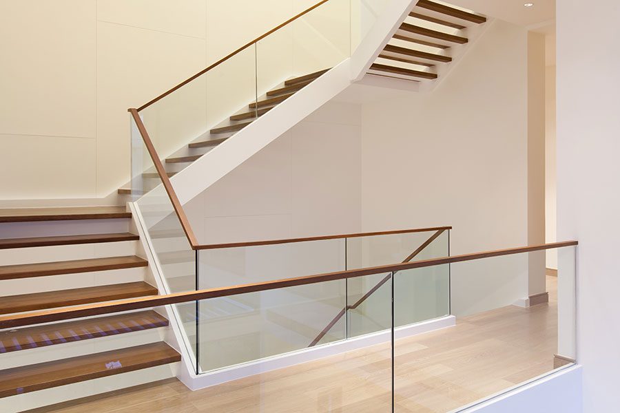 Frameless glass stair balustrade with timber handrail