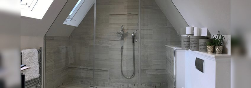 bespoke cut shower screen and door under sloped roof