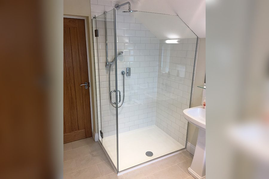 frameless glass shower enclosure with diagonal edge