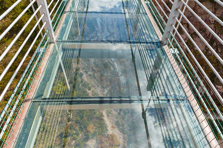 Glass floor on a suspension bridge above a valley