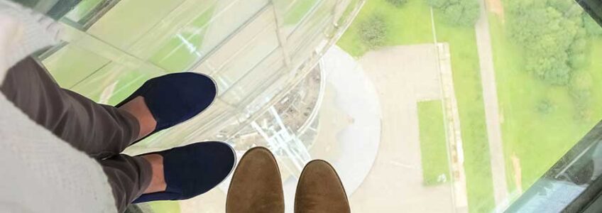 Glass floor panel with view to the ground from a tall building