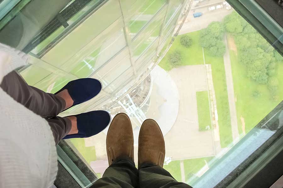 Glass floor panel with view to the ground from a tall building