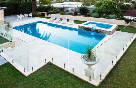 Stunning modern swimming pool with frameless glass pool safety fencing