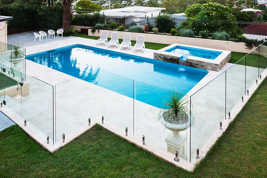 Stunning modern swimming pool with frameless glass pool safety fencing