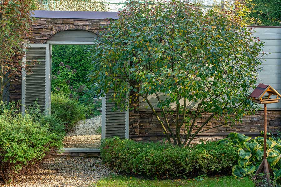 Garden mirror used to give the illusion of a doorway and a bigger space beyond