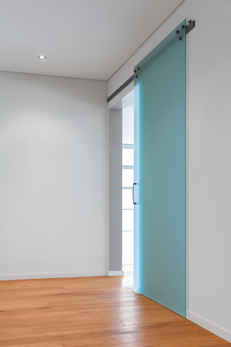 Frosted sliding glass interior door to a bathroom