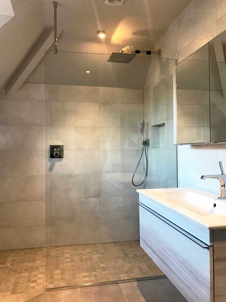 Large frameless loft shower screen in Worplesdon Surrey